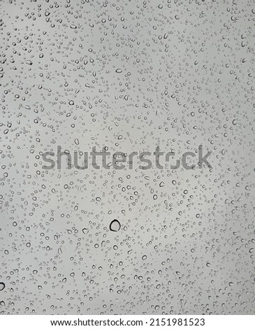 Raindrops on the top window (glass).