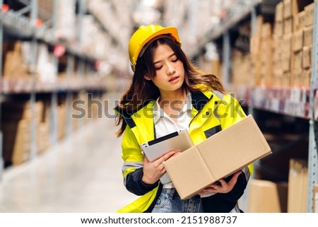 Portrait asian engineer woman shipping order detail on tablet check goods and supplies on shelves with goods background inventory in factory warehouse.logistic industry and business export