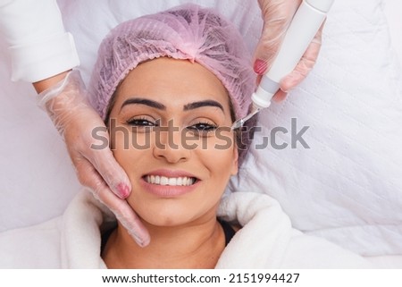 close-up of facial plasma jet on patient, Application of aesthetic procedure, rejuvenation. Royalty-Free Stock Photo #2151994427