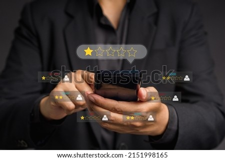 Negative feedback concept. Choosing a 1-star rating review in the survey, poll, or customer satisfaction research. Bad user experience via a smartphone. Customer experience dissatisfied. Poor rating Royalty-Free Stock Photo #2151998165