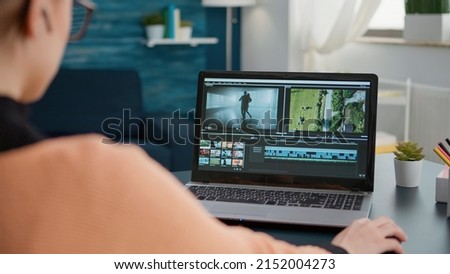 Design student working on video editing software to make montage, creating film for movie footage production. Content creator using multimedia assignment for online school class. Royalty-Free Stock Photo #2152004273