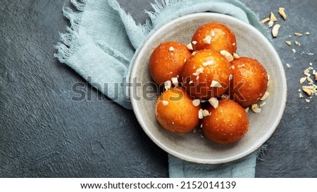 Gulab Jamun on gray background. Traditional oriental food concept. Indian sweet snacks. Top view, flat lay, copy space Royalty-Free Stock Photo #2152014139