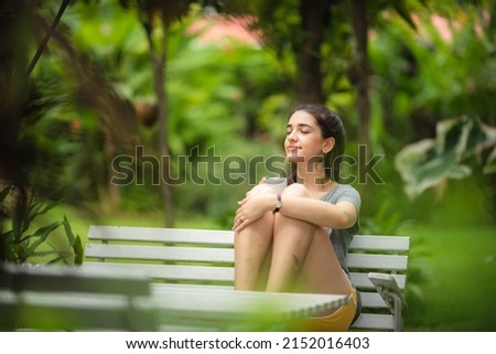 young beautiful woman person are happy and enjoy with coffee drink in the morning at home, relax lifestyle by holding coffee or tea cup at nature outdoor park, smile pretty girl with freedom time Royalty-Free Stock Photo #2152016403