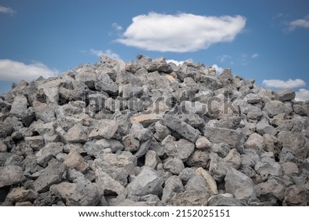 Close-ups of crushed stone for construction and road works against the blue sky