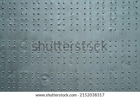 Abstract metal background. Old weathered silver metallic background. Vintage metal texture with rivets and bolts. Sheathing old plane. Old metal texture. High quality photo
