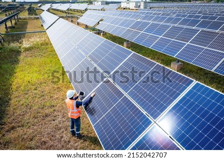 The solar farm(solar panel) with engineers check the operation of the system, Alternative energy to conserve the world's energy, Photovoltaic module idea for clean energy production. Royalty-Free Stock Photo #2152042707