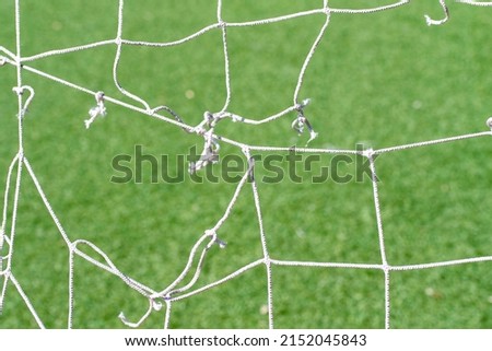 Close-up of an old football goal net.