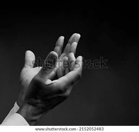 man praying to God with hands together stock photo