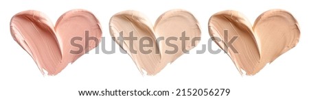 Makeup foundation, cosmetic cream smear in shape of heart isolated on white background. Royalty-Free Stock Photo #2152056279