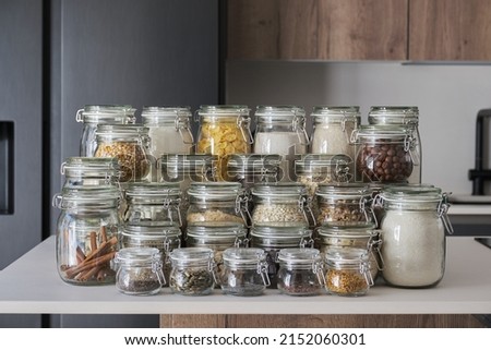 Variety of dry foods, grains, nuts, cereals in glass jars. Zero waste storage concept. Royalty-Free Stock Photo #2152060301