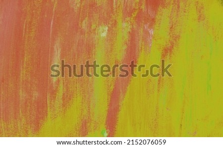 Red-yellow strokes of paint on the surface. Abstract texture.