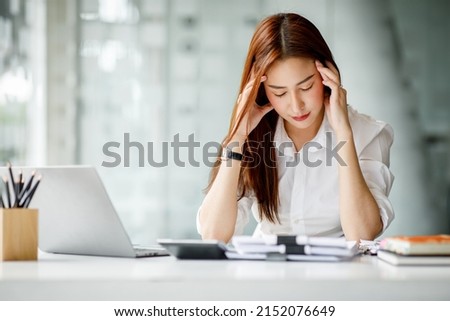 Asian women are stressed while working on laptop, Tired asian businesswoman with headache at office, feeling sick at work, copy space Royalty-Free Stock Photo #2152076649