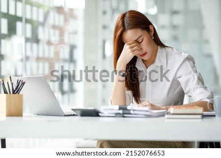 Asian women are stressed while working on laptop, Tired asian businesswoman with headache at office, feeling sick at work, copy space Royalty-Free Stock Photo #2152076653