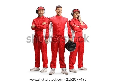 Racer and members of a racing team in red overall suits posing and looking at camera isolated on white background Royalty-Free Stock Photo #2152077493