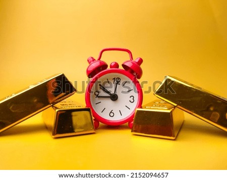 Selective focus.Gold bar with clock conceptual image. Time is a gold.
