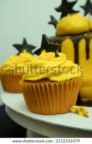 Yellow and black cup cake stock  photograph