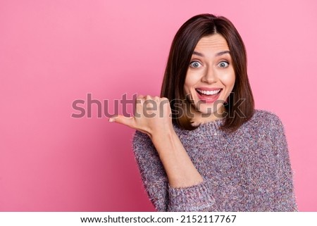Photo of impressed cute woman wear pullover pointing empty space isolated pink color background