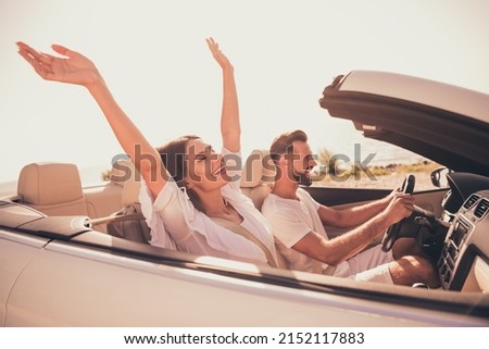 Profile side view portrait of attractive adorable carefree cheerful couple riding car having fun free time outdoors Royalty-Free Stock Photo #2152117883
