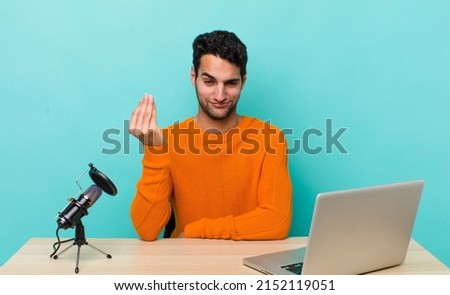 hispanic handsome man making capice or money gesture, telling you to pay. influencer concept