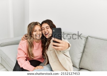 Young couple smiling happy making selfie by the smartphone at home.