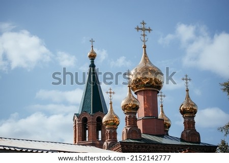 Close-up.Russian Christian Orthodox Church with golden domes and a cross against the sky .The concept of Russian Orthodoxy and Christian faith. Copy space