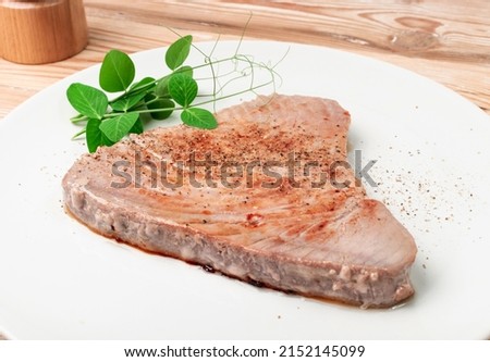 Roasted tuna steak. Red sea fish fillet, medium roast tuna filet, seafood sashimi, bluefin piece, akami, ahi loin, albacore meat cut on white background close up Royalty-Free Stock Photo #2152145099