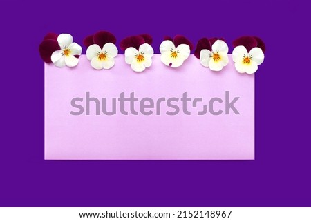 Invitation mockup, empty blank greeting card and yellow purple pansy flowers.