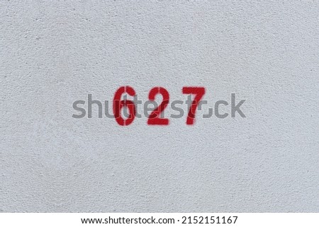 RED Number 627 on the white wall. Spray paint.

