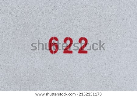 RED Number 622 on the white wall. Spray paint.
