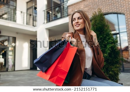 portrait of a beautiful girl with shopping bags on the street. Sales. Shopping. Lifestyle concept