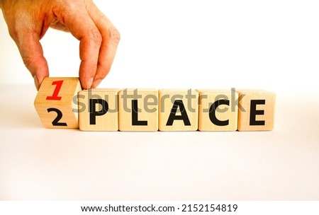 From 2 to 1 place symbol. Businessman turns wooden cubes and changes concept words 2 place to 1 place. Beautiful white table white background. Business and from 2 to 1 place concept. Copy space. Royalty-Free Stock Photo #2152154819