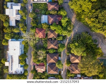 Aerial drone shot of suburb area surrounded by green eco-friendly environment for housing estate project top view