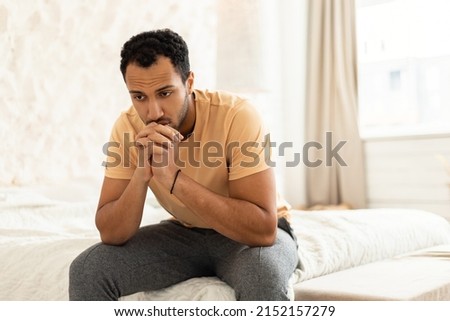 Depressed Middle Eastern Man Suffering From Frustration And Insomnia Sitting Thinking About His Problems In Modern Bedroom At Home. Unhappiness And Stress, Male Depression Concept Royalty-Free Stock Photo #2152157279