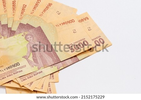 Indonesian rupiah currency notes in five thousand denomination isolated against white background