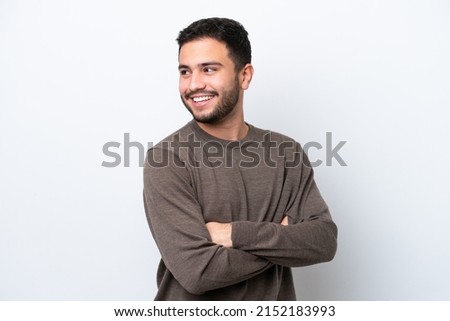 Young Brazilian man isolated on white background looking to the side and smiling Royalty-Free Stock Photo #2152183993