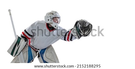 Portrait of young by, teen hockey player, goalkeepr training, catching puck isolated over white studio background. Concept of sportive lifestyle, childhood, hobby, action. Copy space for ad
