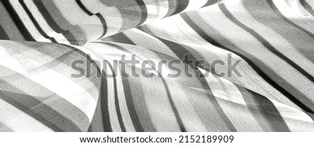 striped silk fabric Black and white. The surface of this fabric can be confused with chased silk - it is so textured and glossy! Consider making your project out of this material. Royalty-Free Stock Photo #2152189909