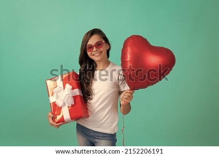happy teen girl in sunglasses hold gift box and valentines day party heart balloon, flash sale