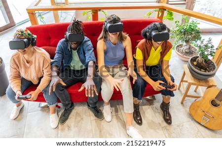 International of group of friends playing on vr glasses indoor - Young people having fun together connecting with headset goggles. Social and digital generation trends