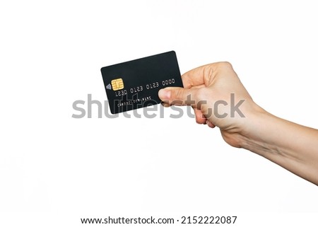 A female hand holding a black plastic credit card with blank for text or design isolated on a white background. Shopping, payment for purchases, banking operations. Mockup with empty copy space Royalty-Free Stock Photo #2152222087