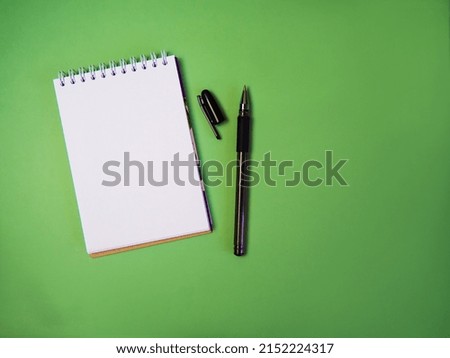 open blank notepad on green background,copy space