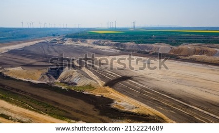Panorama of Garzweiler surface mine in Germany with heavy machinery and power plant in the distance Royalty-Free Stock Photo #2152224689