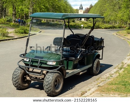 Golf cart on the track in the park Royalty-Free Stock Photo #2152228165
