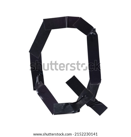 The letter Q is made with pieces of black electrical tape on a white background, close-up, decorative font, letters and numbers from black tape
