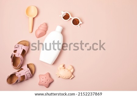 Kids summer accesories and sun screen bottle for sunny days and vacations. Sunglasses, sandals, sand molds for beach fun time 
