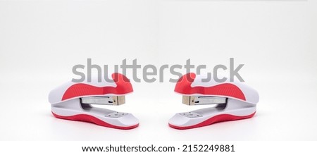 School office supplies red staplers on white background with space
