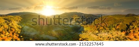 Ukraine. Sunrise shines in the Carpathians, colored fog spreads over the valleys and lowlands of the mountain range, golden prairies are very dazzlingly beautiful.