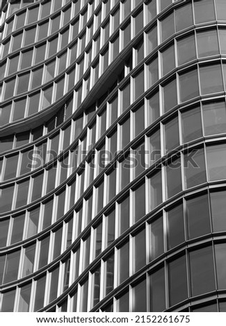 Architecture exterior facade view of modern building wall with lights and shadows. Modern urban architecture is a waves shaped building abstract background. Street photo, nobody, selective focus
