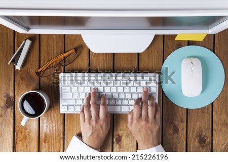 Businesswoman using pc computer on her office table Royalty-Free Stock Photo #215226196