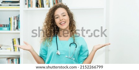 Beautiful caucasian female nurse or medical student with curly hair at hospital